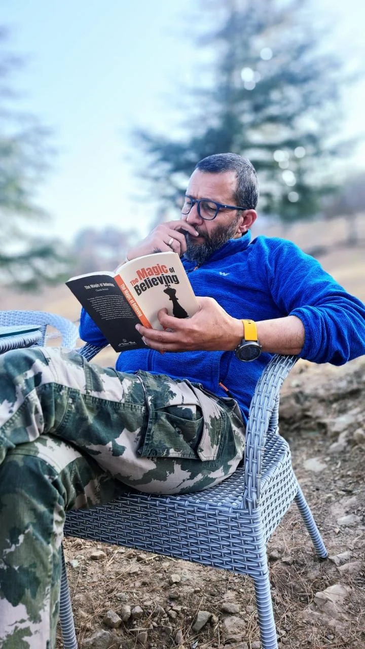 Trilok Singh reading outdoors in Himachal Pradesh